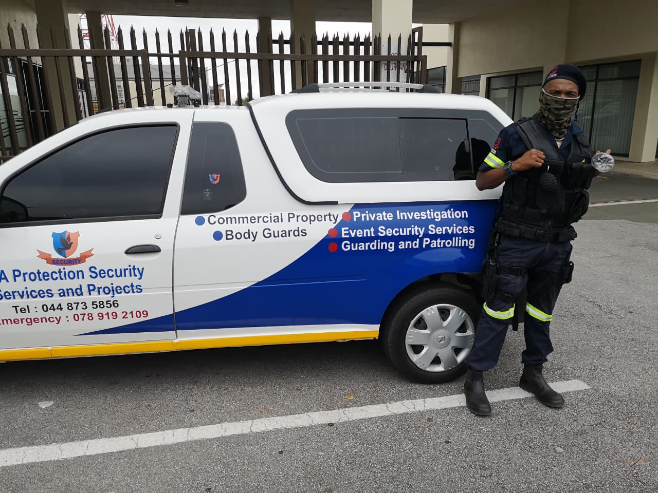 Security guard with tactical gear next to BAPSS security vehicle